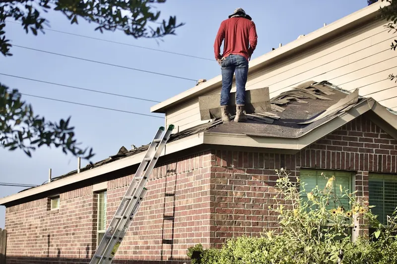 Professional roofer working on a residential roof in South Setauket